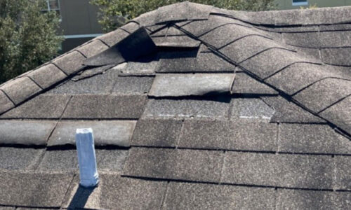 Damaged shingle roof before repair in Orlando FL